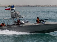 An Islamic Revolutionary Guard Corps (IRGC) speed boat is sailing along the Persian Gulf during the IRGC marine parade to commemorate Persia...