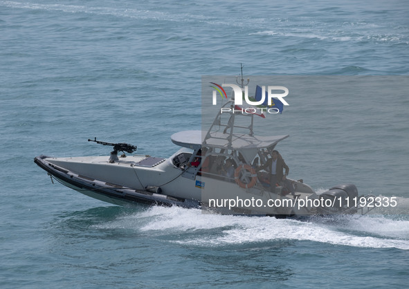 An Islamic Revolutionary Guard Corps (IRGC) speed boat is sailing along the Persian Gulf during the IRGC marine parade to commemorate Persia...