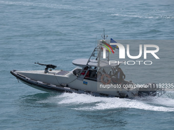 An Islamic Revolutionary Guard Corps (IRGC) speed boat is sailing along the Persian Gulf during the IRGC marine parade to commemorate Persia...