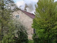 A chimney smoke is seen over a residential house in a village near Sandomierz, central Poland on April 29, 2024. (