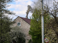 A chimney smoke is seen over a residential house in a village near Sandomierz, central Poland on April 29, 2024. (