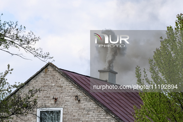 A chimney smoke is seen over a residential house in a village near Sandomierz, central Poland on April 29, 2024. 