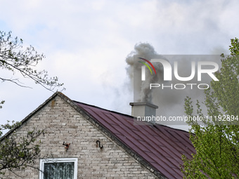 A chimney smoke is seen over a residential house in a village near Sandomierz, central Poland on April 29, 2024. (