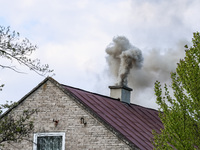 A chimney smoke is seen over a residential house in a village near Sandomierz, central Poland on April 29, 2024. (