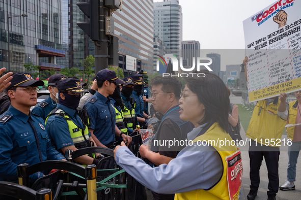 Service Union members are facing police obstruction outside the U.S. Embassy in Seoul, South Korea, on April 30, 2024, as they attempt to de...