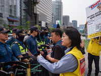 Service Union members are facing police obstruction outside the U.S. Embassy in Seoul, South Korea, on April 30, 2024, as they attempt to de...