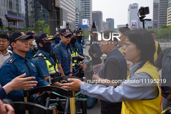 Service Union members are facing police obstruction outside the U.S. Embassy in Seoul, South Korea, on April 30, 2024, as they attempt to de...