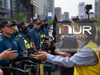 Service Union members are facing police obstruction outside the U.S. Embassy in Seoul, South Korea, on April 30, 2024, as they attempt to de...