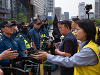 Service Union members are facing police obstruction outside the U.S. Embassy in Seoul, South Korea, on April 30, 2024, as they attempt to de...