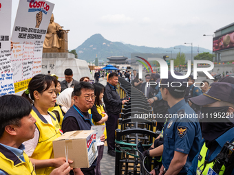 Service Union members are facing police obstruction outside the U.S. Embassy in Seoul, South Korea, on April 30, 2024, as they attempt to de...