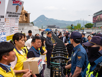 Service Union members are facing police obstruction outside the U.S. Embassy in Seoul, South Korea, on April 30, 2024, as they attempt to de...