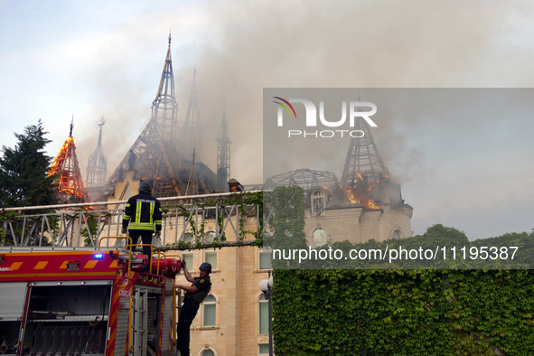 Rescuers are operating a fire engine outside the Palace of Students of the Odesa Law Academy, which caught fire due to a Russian missile att...