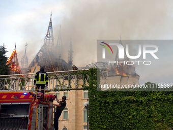 Rescuers are operating a fire engine outside the Palace of Students of the Odesa Law Academy, which caught fire due to a Russian missile att...