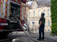 A rescuer is standing by a fire engine outside the Palace of Students of the Odesa Law Academy, which is on fire due to a Russian missile at...