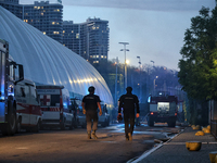 First responders are pictured outside the Palace of Students of the Odesa Law Academy, which is on fire as a result of a Russian missile att...