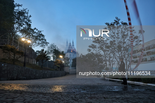 A police officer is standing guard outside the Palace of Students of the Odesa Law Academy, which is on fire as a result of a Russian missil...