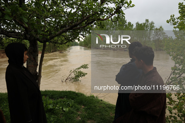 Kashmiri farmers are inspecting their orchards that have been washed away by flash floods in Nathipora Sopore, District Baramulla, Jammu and...