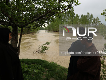 Kashmiri farmers are inspecting their orchards that have been washed away by flash floods in Nathipora Sopore, District Baramulla, Jammu and...