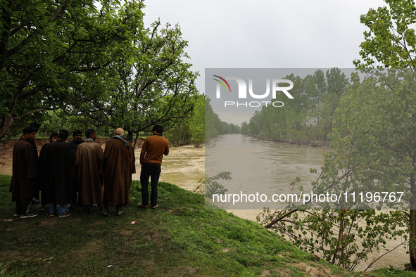 Kashmiri farmers are inspecting their orchards that have been washed away by flash floods in Nathipora Sopore, District Baramulla, Jammu and...