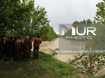 Kashmiri farmers are inspecting their orchards that have been washed away by flash floods in Nathipora Sopore, District Baramulla, Jammu and...