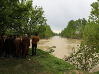 Kashmiri farmers are inspecting their orchards that have been washed away by flash floods in Nathipora Sopore, District Baramulla, Jammu and...