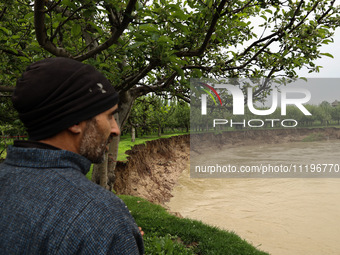 Kashmiri farmers are inspecting their orchards that have been washed away by flash floods in Nathipora Sopore, District Baramulla, Jammu and...