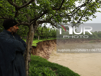 Kashmiri farmers are inspecting their orchards that have been washed away by flash floods in Nathipora Sopore, District Baramulla, Jammu and...