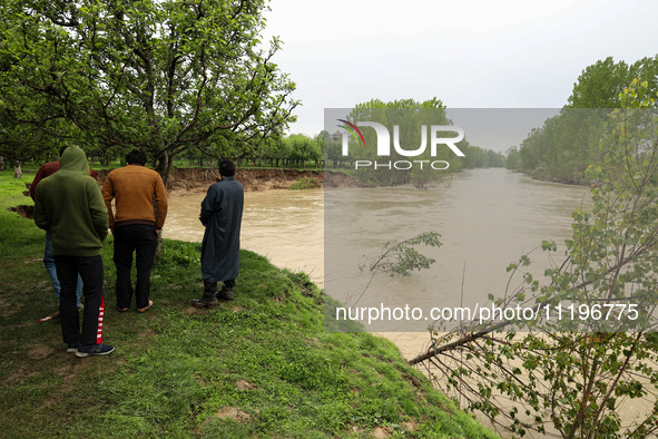 Kashmiri farmers are inspecting their orchards that have been washed away by flash floods in Nathipora Sopore, District Baramulla, Jammu and...