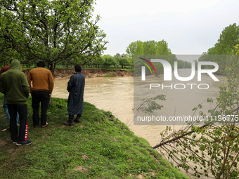 Kashmiri farmers are inspecting their orchards that have been washed away by flash floods in Nathipora Sopore, District Baramulla, Jammu and...