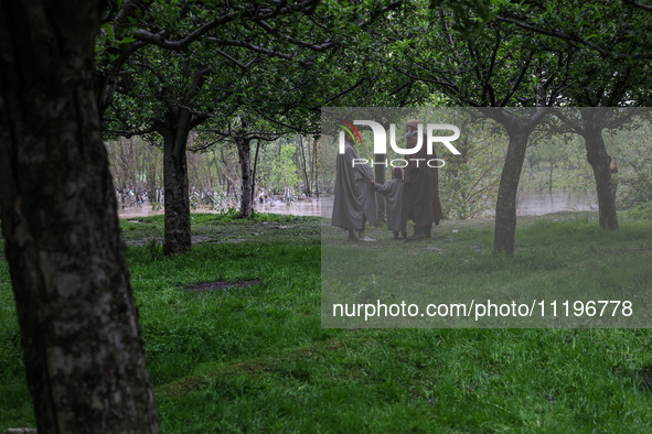 Kashmiri farmers are inspecting their orchards that have been washed away by flash floods in Nathipora Sopore, District Baramulla, Jammu and...