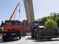 Workers are dismantling the monument commemorating the Pereiaslav Agreement under the Arch of Freedom of the Ukrainian People, formerly know...