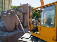 Workers are dismantling the monument commemorating the Pereiaslav Agreement under the Arch of Freedom of the Ukrainian People, formerly know...