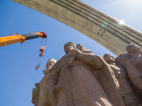 Workers are dismantling the monument commemorating the Pereiaslav Agreement under the Arch of Freedom of the Ukrainian People, formerly know...