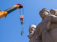 Workers are dismantling the monument commemorating the Pereiaslav Agreement under the Arch of Freedom of the Ukrainian People, formerly know...