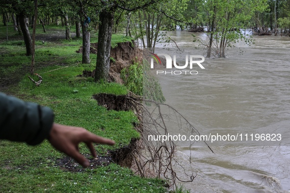 Kashmiri farmers are inspecting their orchards that have been washed away by flash floods in Nathipora Sopore, District Baramulla, Jammu and...