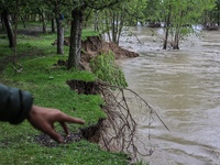 Kashmiri farmers are inspecting their orchards that have been washed away by flash floods in Nathipora Sopore, District Baramulla, Jammu and...