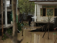 A person is inspecting his house that has been submerged due to flash floods on the outskirts of Sopore, District Baramulla, Jammu and Kashm...