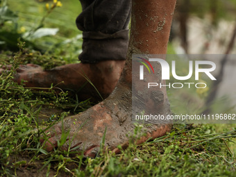 The feet of Ghulam Mohammad, 78, are pictured outside his house, which is submerged due to flash floods on the outskirts of Sopore, District...