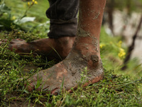 The feet of Ghulam Mohammad, 78, are pictured outside his house, which is submerged due to flash floods on the outskirts of Sopore, District...