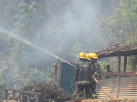 Nepali firefighters are using water cannons to control a blaze that started in a local forest in the Lalitpur District of Central Nepal, on...