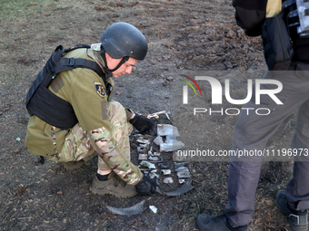 An expert is working at the scene where Russian guided bombs landed in Kharkiv, northeastern Ukraine, on April 29, 2024. NO USE RUSSIA. NO U...