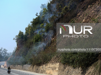 A forest fire is billowing smoke in a local community forest in Lalitpur, Central Nepal, on April 30, 2024. (