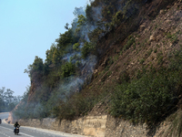 A forest fire is billowing smoke in a local community forest in Lalitpur, Central Nepal, on April 30, 2024. (