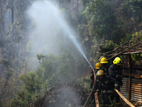 Nepali firefighters are attempting to douse a forest fire in Lalitpur District, Nepal, on April 30, 2024. (