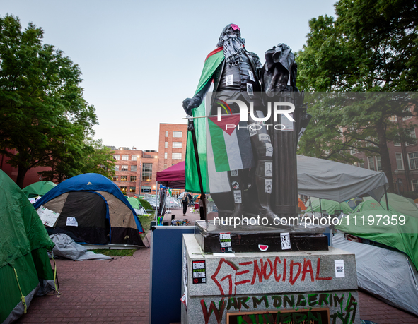 The statue of George Washington at the university bearing his name is surrounded by a Gaza solidarity encampment, Washington, DC, April 29,...