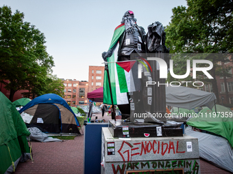 The statue of George Washington at the university bearing his name is surrounded by a Gaza solidarity encampment, Washington, DC, April 29,...