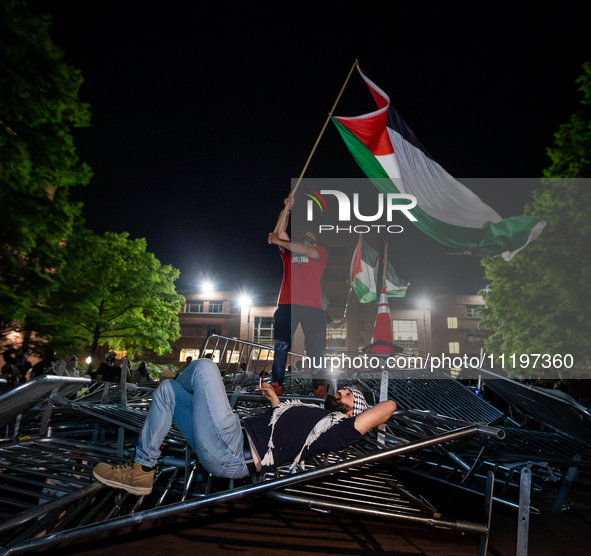 Students protest atop of a pile of barricades at George Washington University, Washington, DC, April 29, 2024.  Students broke through the b...