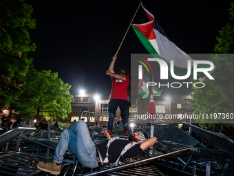 Students protest atop of a pile of barricades at George Washington University, Washington, DC, April 29, 2024.  Students broke through the b...