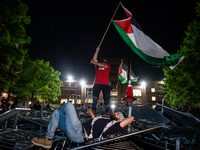 Students protest atop of a pile of barricades at George Washington University, Washington, DC, April 29, 2024.  Students broke through the b...