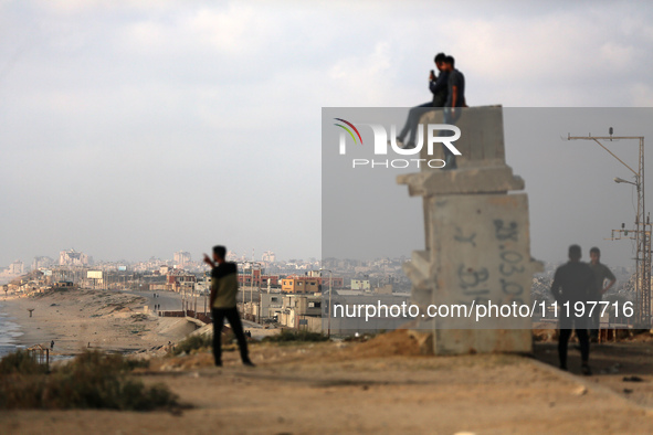 Palestinians are walking along the coastal Rashid road in the Nuseirat refugee camp in the central Gaza Strip on April 30, 2024, amid the on...